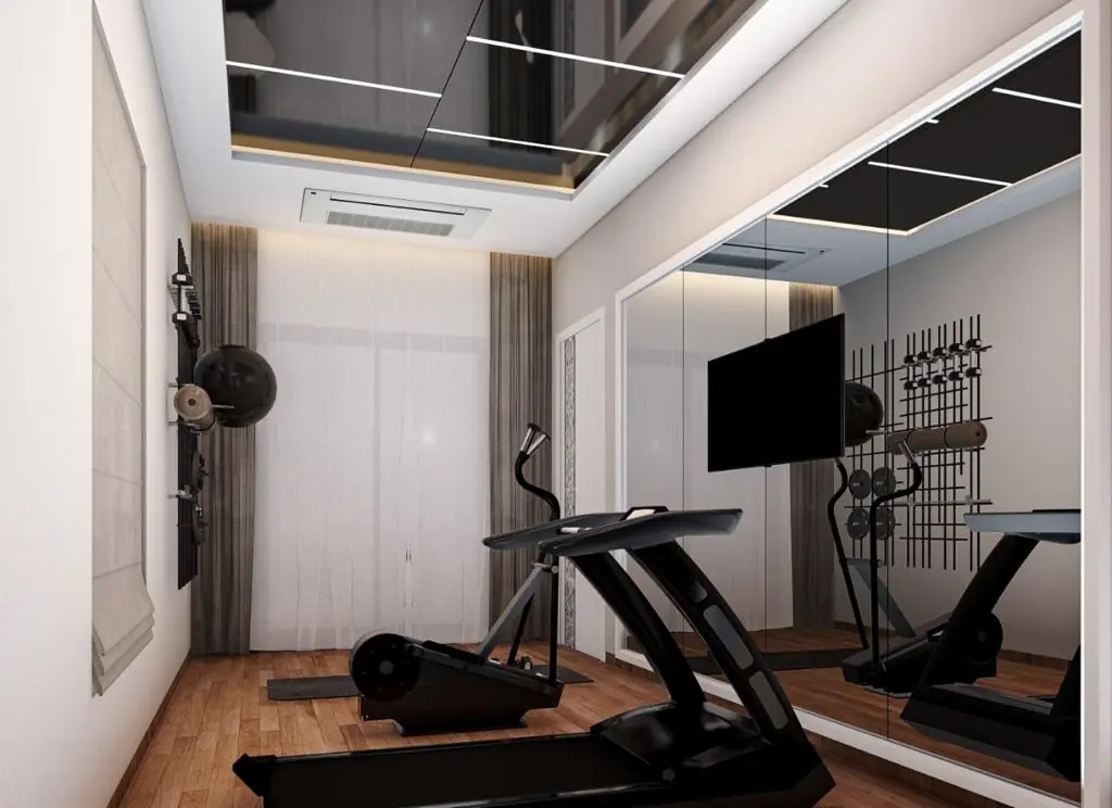 Home gym with mirrored wall and treadmill