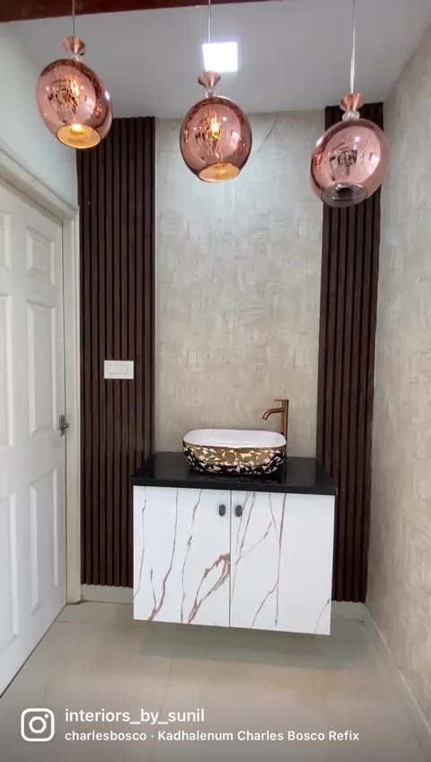 Fluted-panel vanity with copper pendant lights