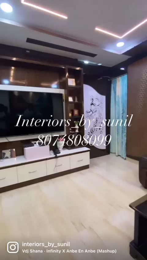 Living room with feature wall and cove-lit ceiling